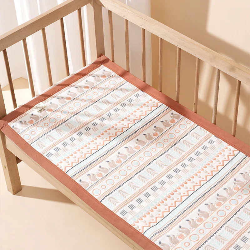Patterned baby crib mattress pad with cute animal print and soft border, perfect for nursery bedding